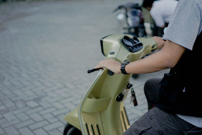 High angle view of man sitting on street