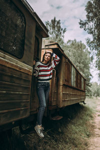 Woman standing in rusty train