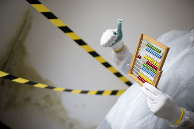 Cropped hand of scientist holding thermometer