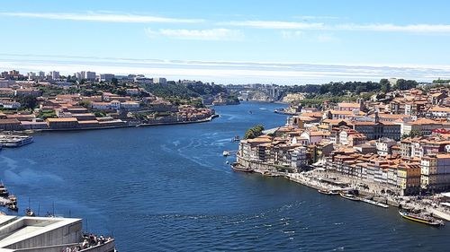 High angle view of townscape by sea against sky