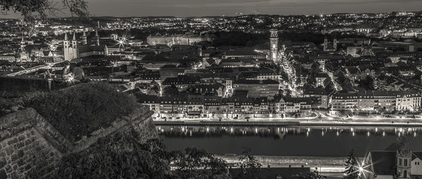 Aerial view of illuminated cityscape against sky