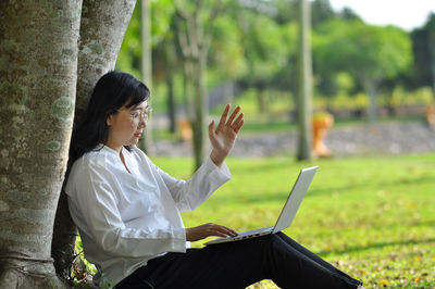 Side view of woman using mobile phone