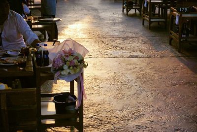 Low section of person with flowers on chair