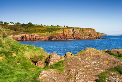 Scenic view of sea against clear blue sky