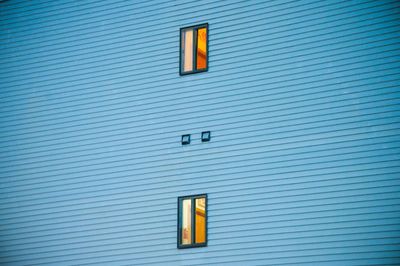 Low angle view of windows on blue building