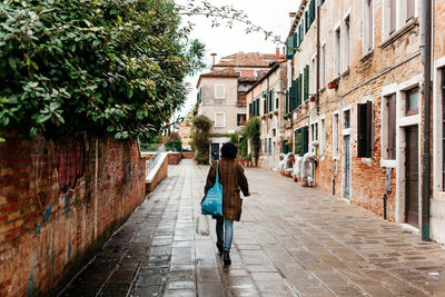 Rear view of woman walking on street