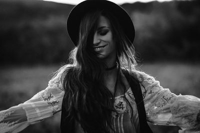 Portrait of smiling young woman standing outdoors