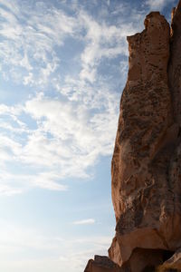 Low angle view of rock formation against sky