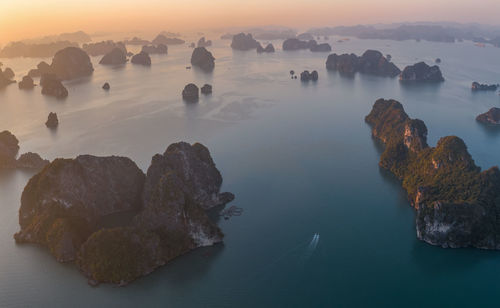 High angle view of rocks in sea against sky