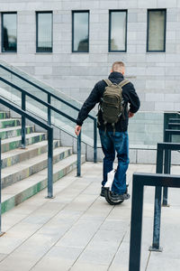 Man riding fast on electric unicycle on city street. mobile portable individual transportation