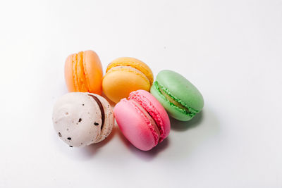 High angle view of multi colored candies against white background