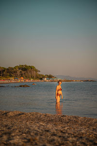 Young woman at italian beach while sunset
