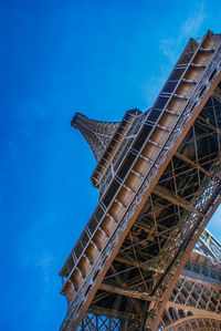 Low angle view of eiffel tower against clear blue sky