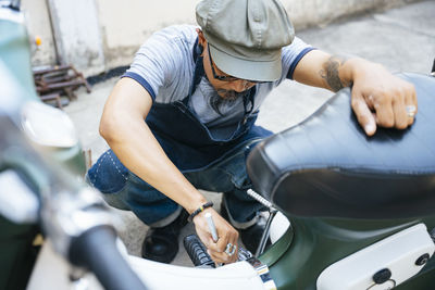 High angel view of mechanic working in garage