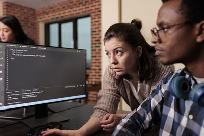 Young woman using laptop at office