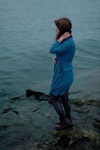 Rear view of woman standing on beach