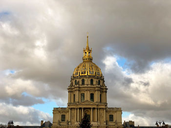 Low angle view of building against cloudy sky hôtel des invalides paris france