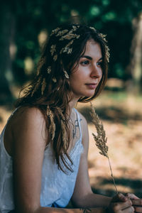 Portrait of young woman looking away outdoors