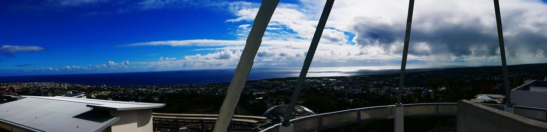 Panoramic view of sea and buildings against sky