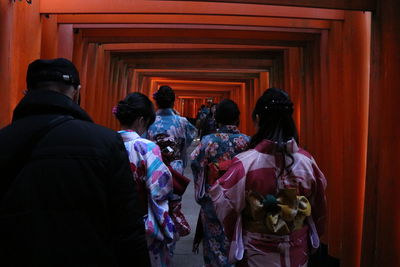 Rear view of people standing in corridor