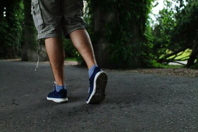 Low section of man wearing shoes