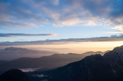 Scenic view of silhouette mountains against sky during sunset