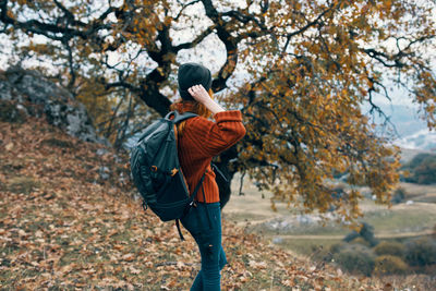 Full length of man standing on tree