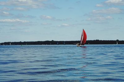 Sailboat on sea against sky