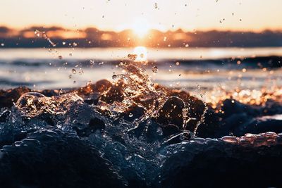 Close-up of water splashing at sunrise