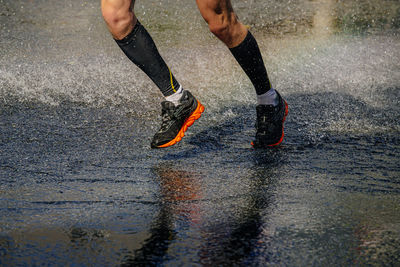 Male athlete in compression socks run water