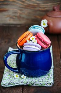 Macaroons in mug on table