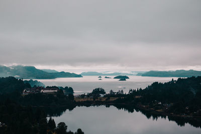 Scenic view of lake against cloudy sky