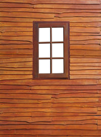 Full frame shot of window on wooden wall of building