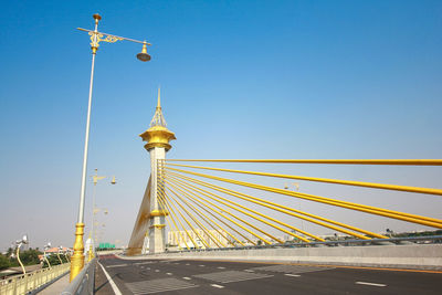 Low angle view of bridge against clear blue sky