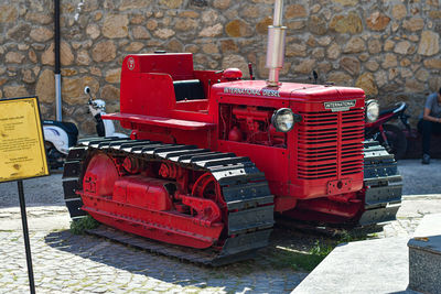 Red vintage car on street in city