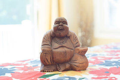 Close-up of man sitting on table at home