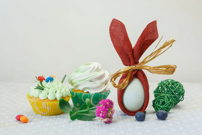 Close-up of multi colored flowers on table against white background