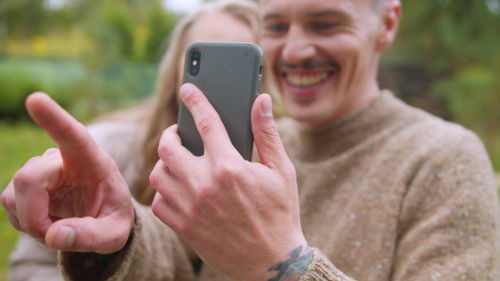 Couple doing selfie while standing outdoors