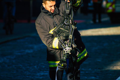 Side view of man holding umbrella