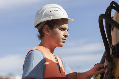 Young engineer working outside at photo voltaic station