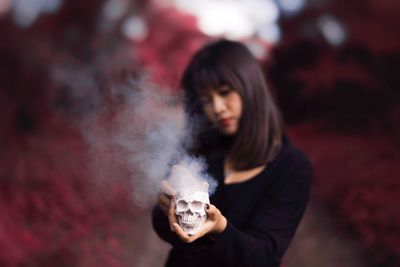 Portrait of beautiful young woman standing outdoors