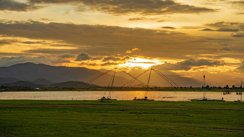 Scenic view of field against sky during sunset