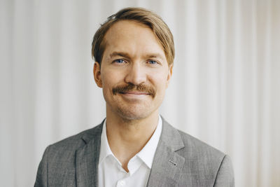 Portrait of businessman standing in office