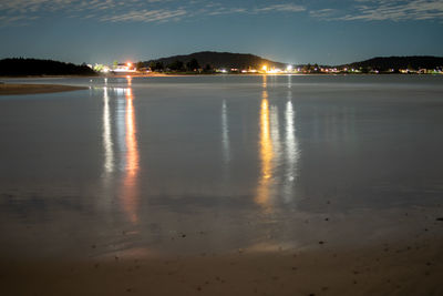 Scenic view of lake against sky at night