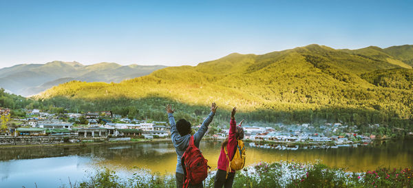 Scenic view of lake and mountains against clear sky