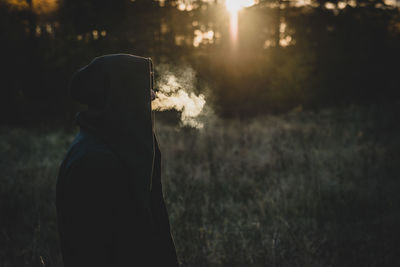 Silhouette person standing on field