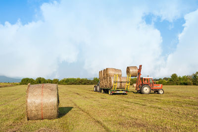 Tractor on agricultural field against sky