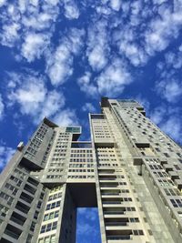 Low angle view of building against cloudy sky