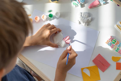 High angle view of girl drawing on table