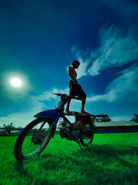 Man riding bicycle on field